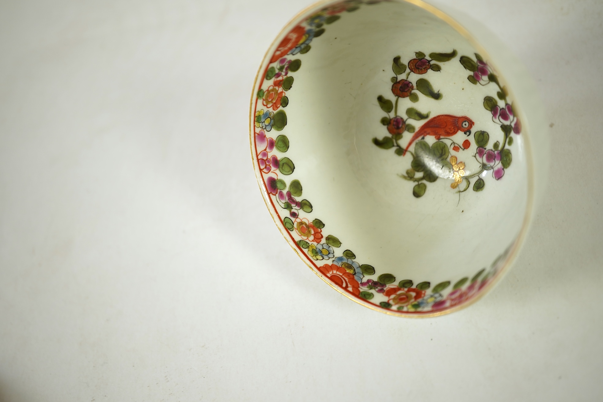 A Worcester Old Worcester Parrot pattern tea bowl and saucer, c.1765-68, saucer 11.5cm in diameter